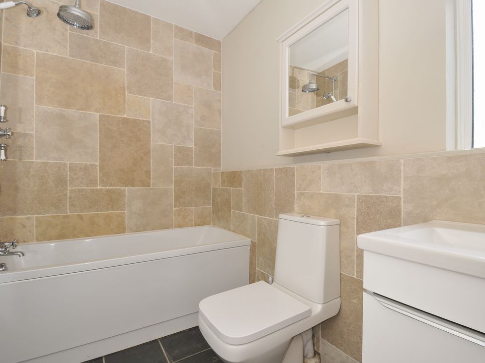 A bathroom with a bathtub, toilet, and sink at 4 Polgrain Turning St. Wenn near St Columb Major