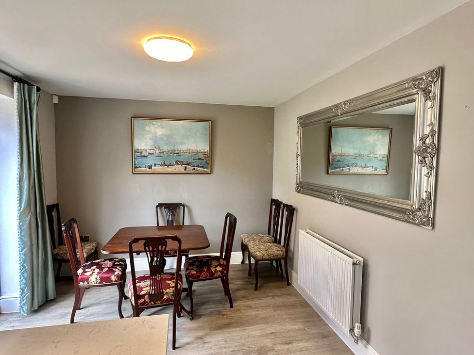 A dining room with a table and chairs at 2 Clarke Close in Cottenham