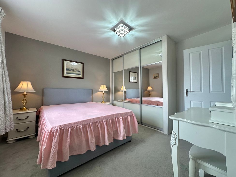 A bedroom with a bed and lamps at 2 Clarke Close in Cottenham