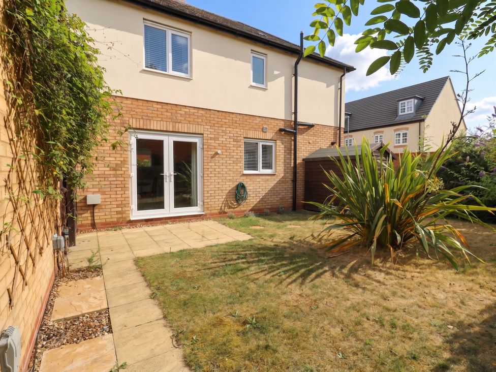 A garden with a patio and plants at 2 Clarke Close Cottenham