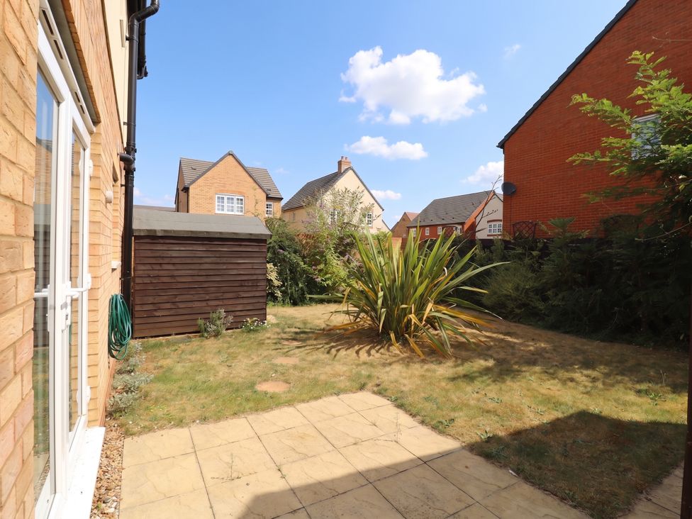 A garden with a shed and plant at 2 Clarke Close Cottenham