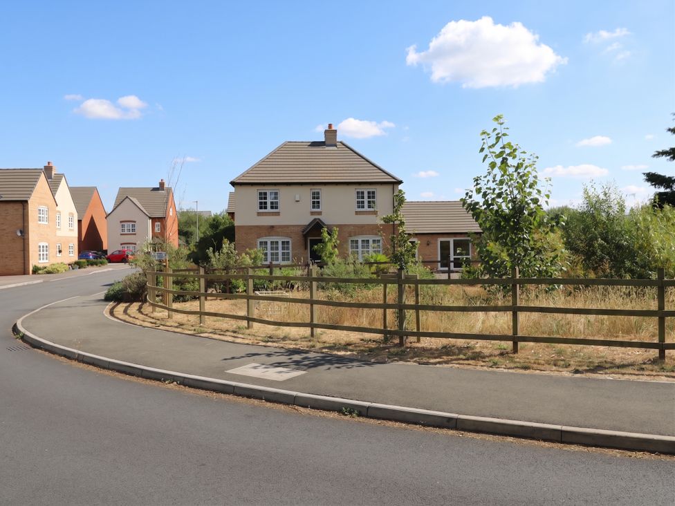 A house with a fence and trees on the street at 2 Clarke Close Cottenham