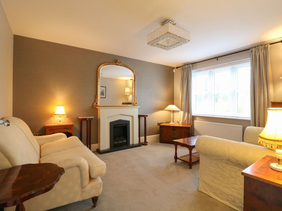 A living room with a sofa and coffee table at 2 Clarke Close in Cottenham