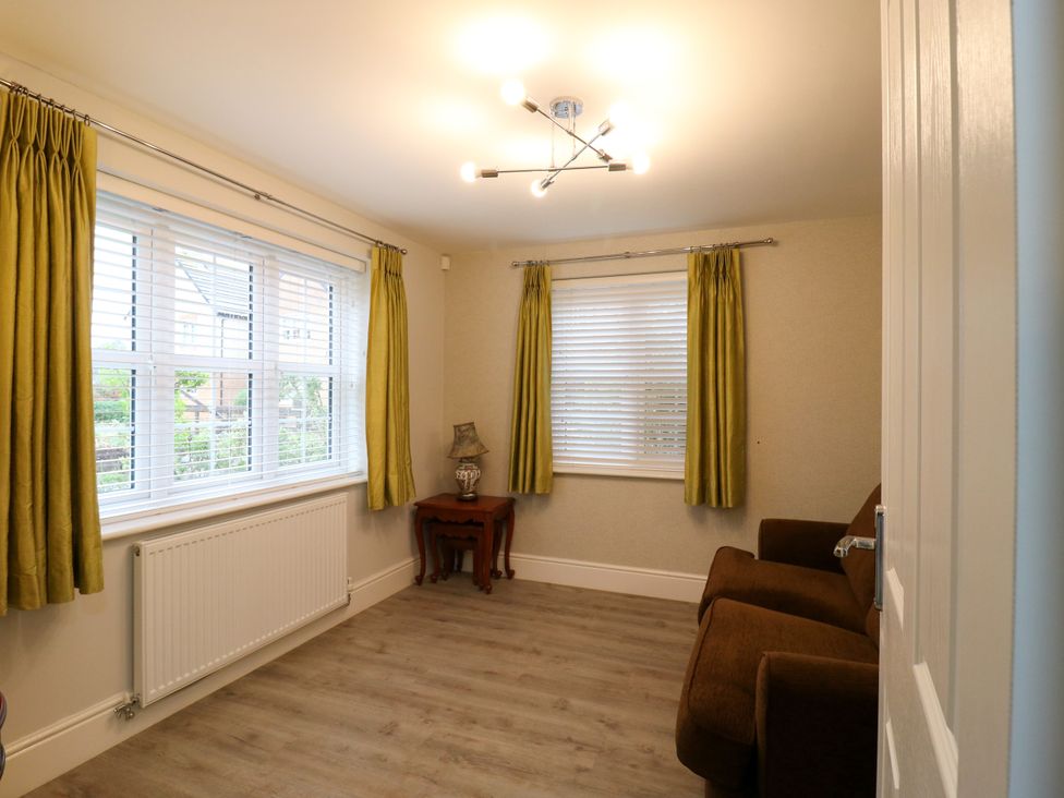 A living room with a sofa and table at 2 Clarke Close in Cottenham