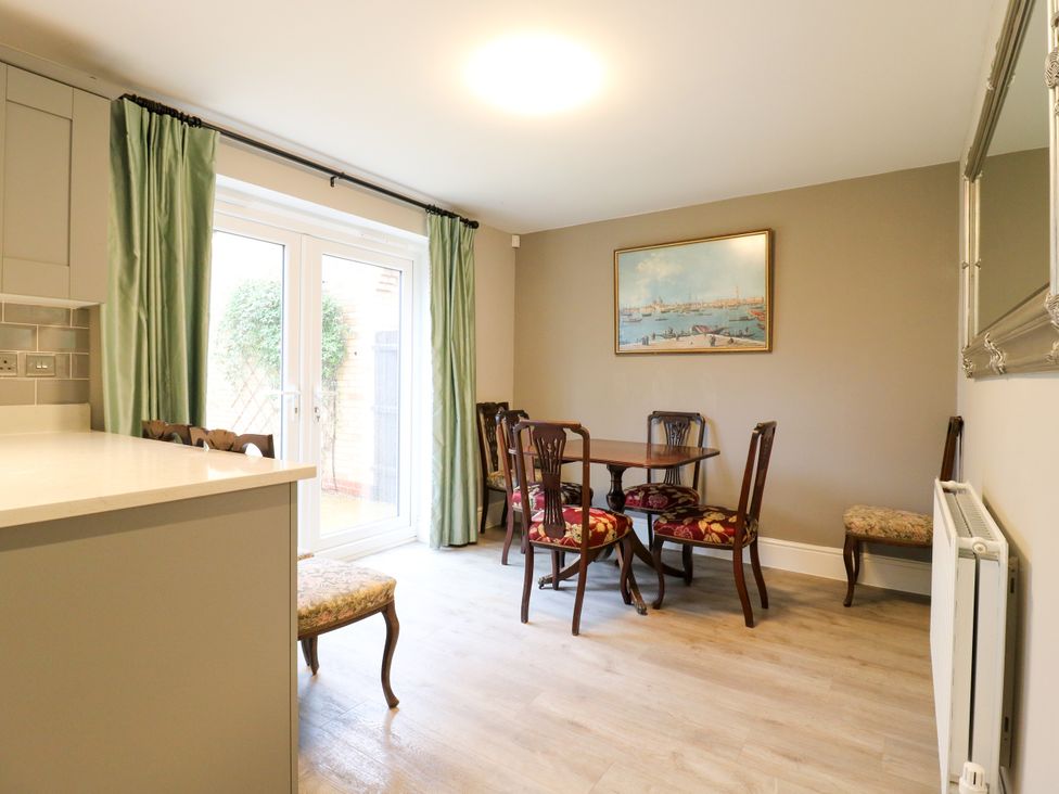 A dining room with a table and chairs at 2 Clarke Close in Cottenham