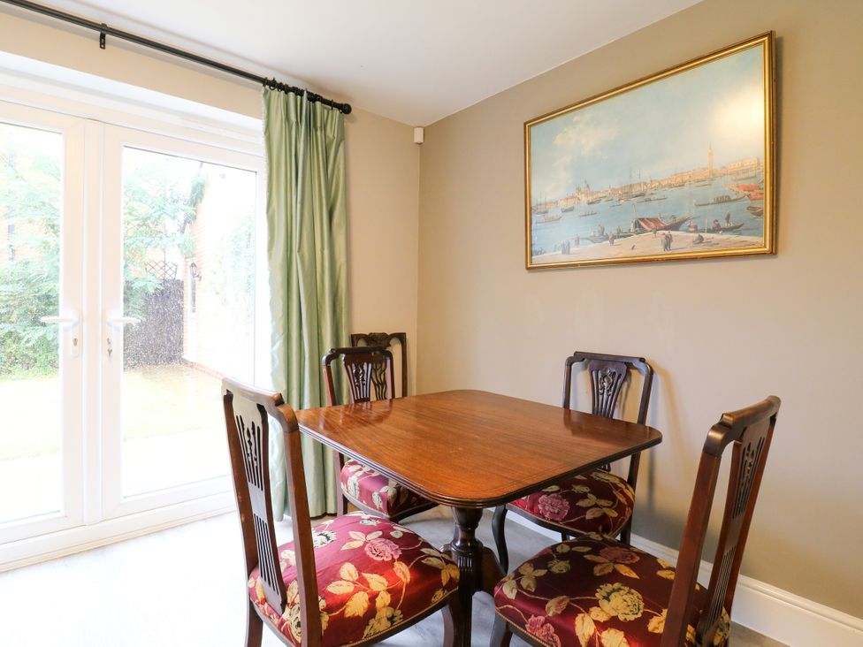 A dining room with a table and chairs at 2 Clarke Close Cottenham