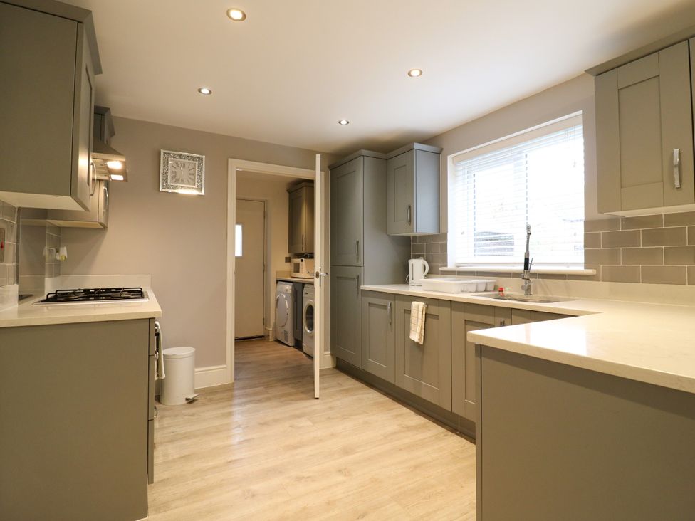 A kitchen with cabinets and appliances at 2 Clarke Close Cottenham