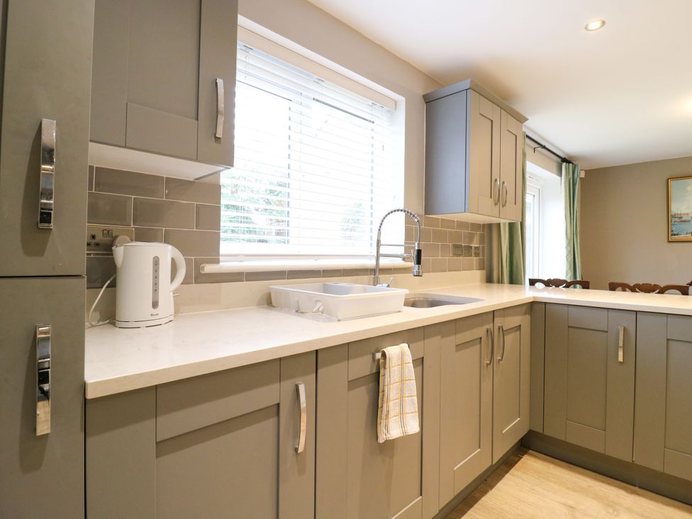 A kitchen with a sink and kettle at 2 Clarke Close in Cottenham