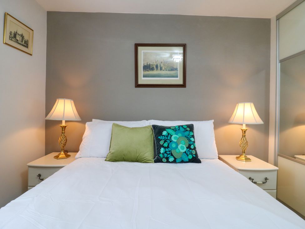 A bedroom with a bed and lamps at 2 Clarke Close in Cottenham