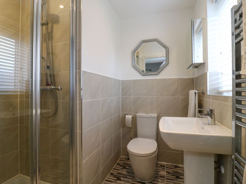 A bathroom with shower, toilet, and sink at 2 Clarke Close in Cottenham