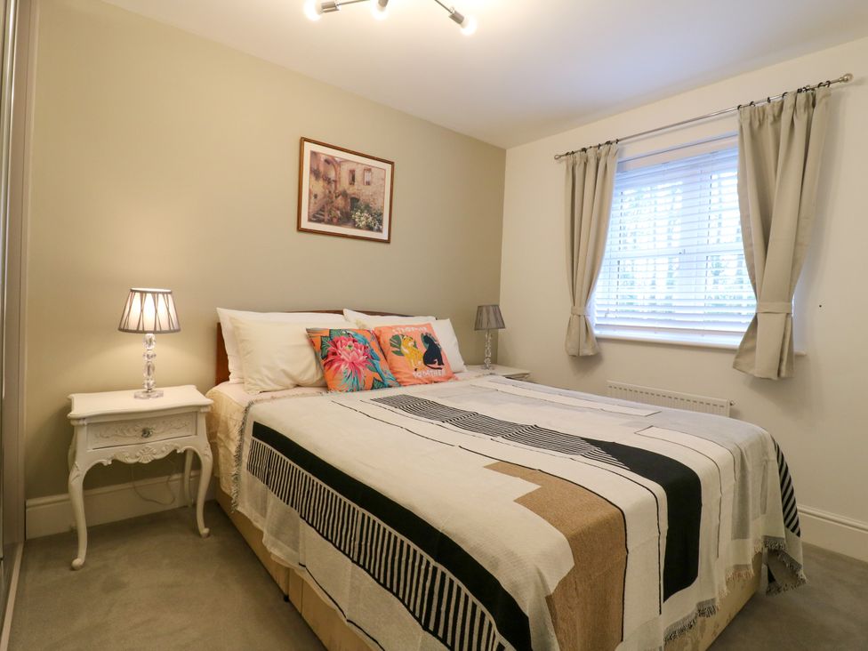A bedroom with a bed and bedside table at 2 Clarke Close Cottenham