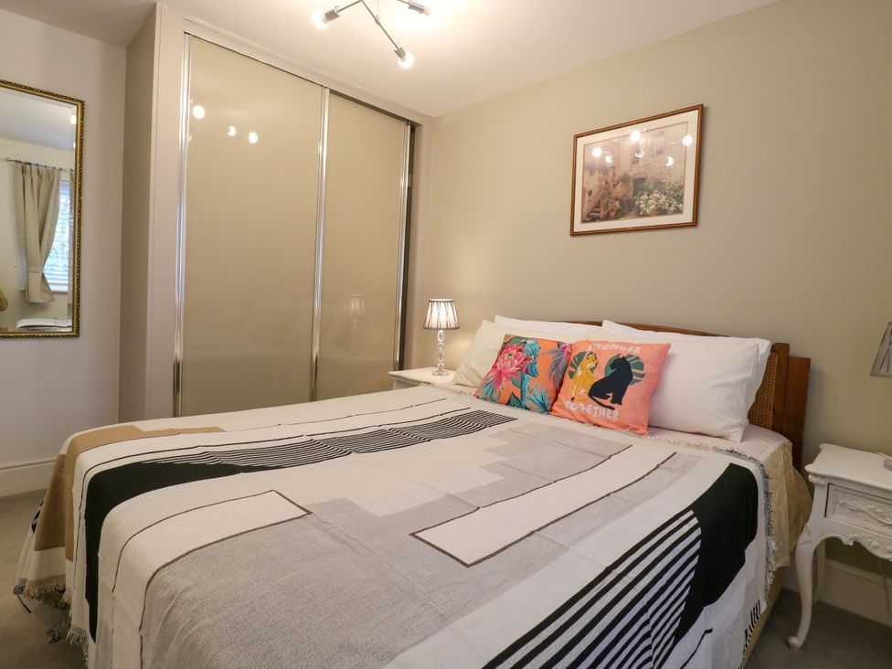 A bedroom with a bed and wardrobe at 2 Clarke Close in Cottenham
