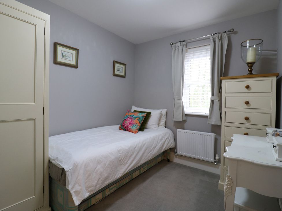 A bedroom with a bed and dresser at 2 Clarke Close in Cottenham