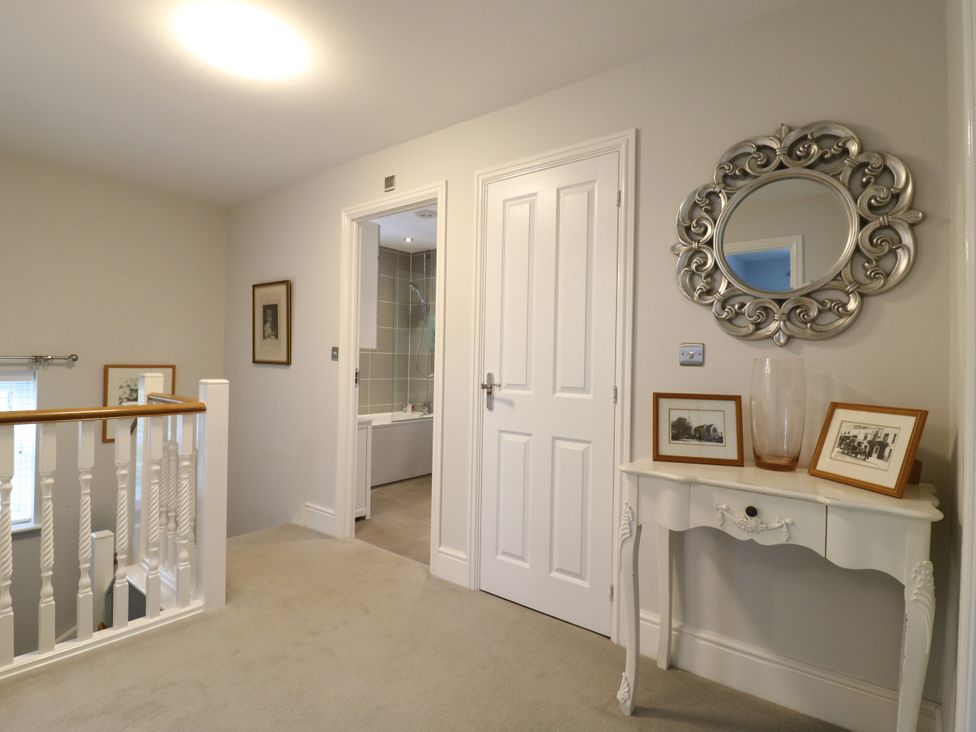 A hallway with a console table and pictures at 2 Clarke Close in Cottenham