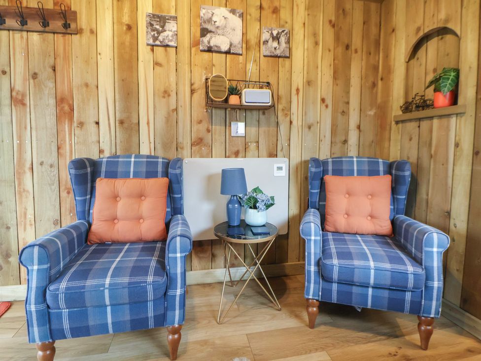A sitting room with two chairs and a table at The Suffolk in Knutsford