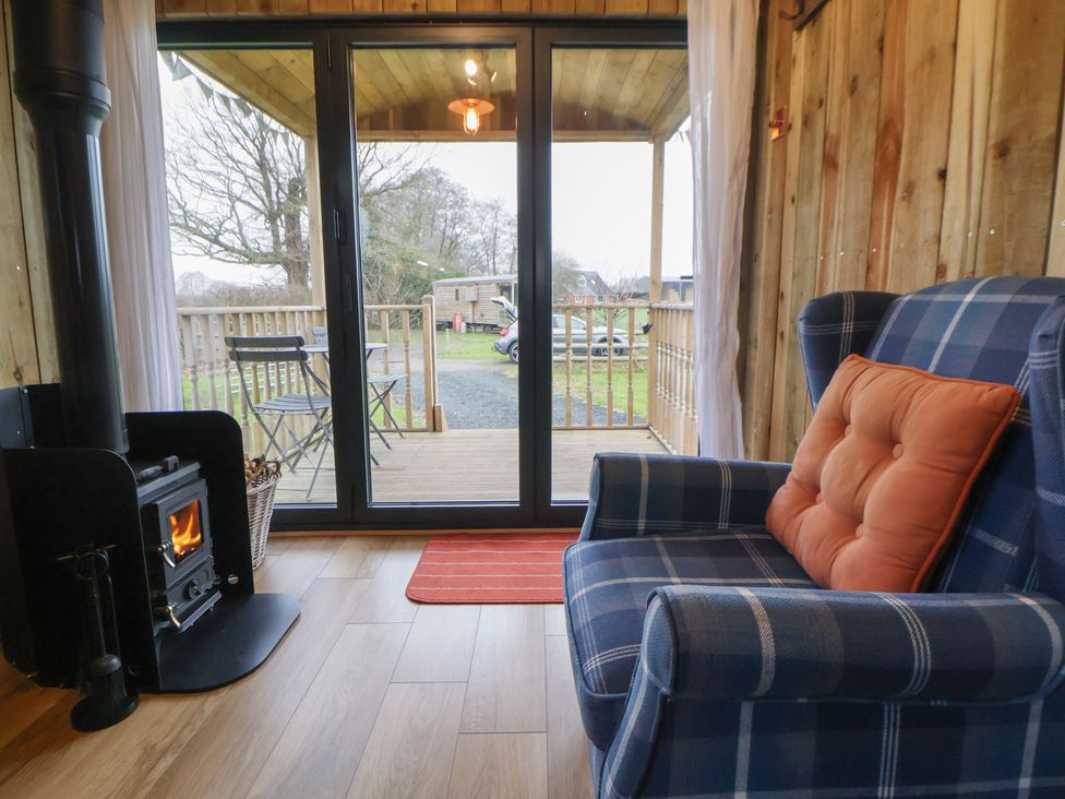 A snug with a wood stove and rocking chair at The Suffolk in Knutsford
