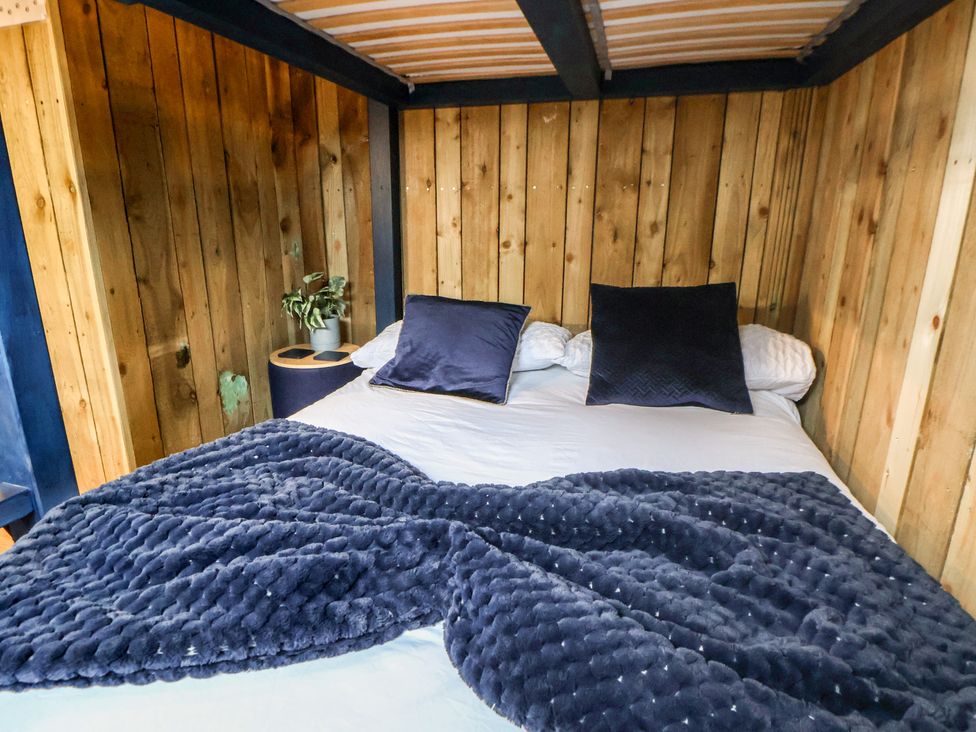 A bed with pillows and blanket at The Suffolk in Knutsford
