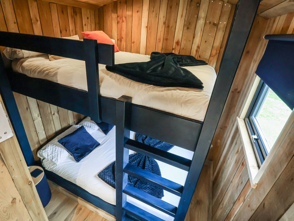 A bunk bed in a wooden bedroom at The Suffolk in Knutsford