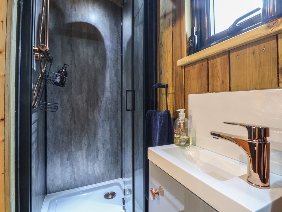 A bathroom with a shower and sink at The Suffolk in Knutsford