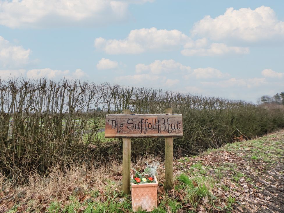 A sign for The Suffolk Hut with flowers at The Suffolk Hut in Knutsford