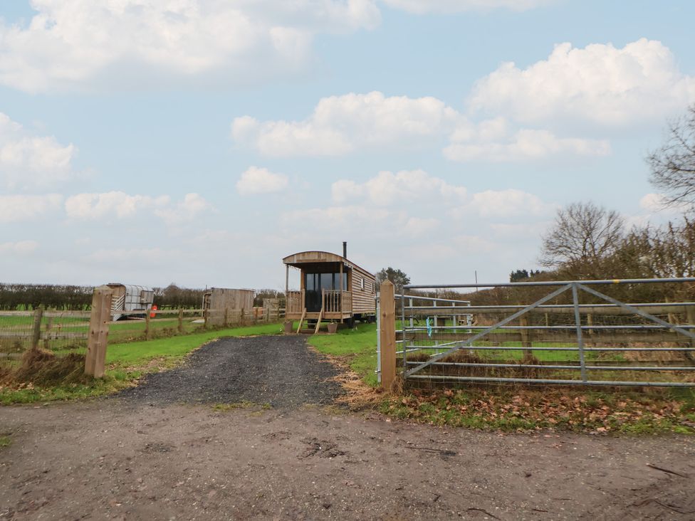 A building with a gate and gravel path at The Suffolk in Knutsford