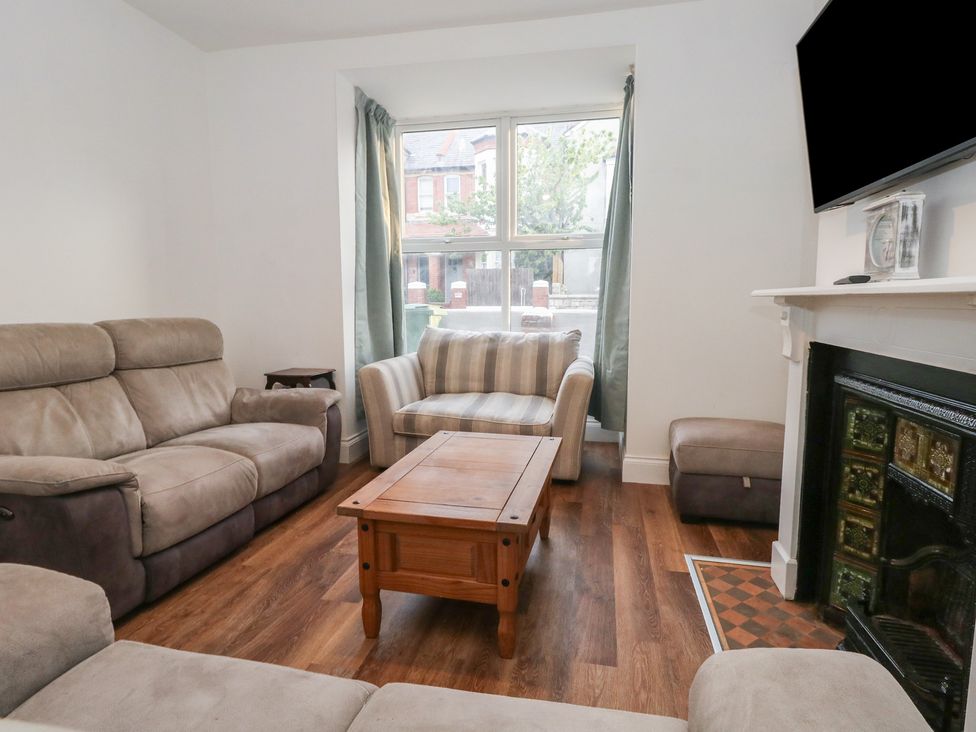 A living room with sofas and a coffee table at 93 Abbotsbury Road in Weymouth