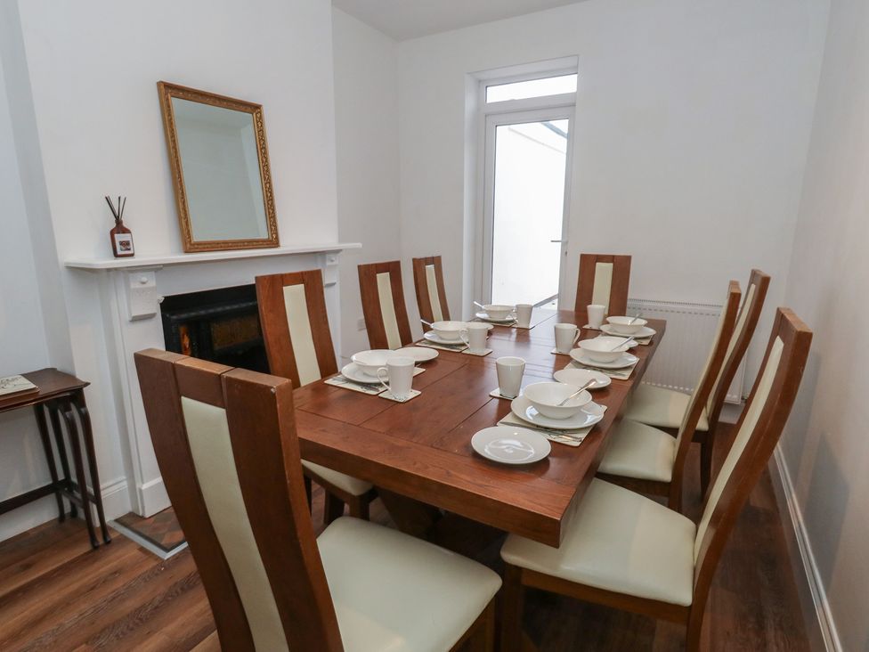 A dining room with a table set for meals at 93 Abbotsbury Road in Weymouth