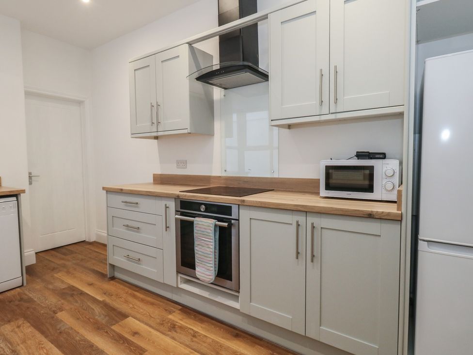 A kitchen with cabinets and appliances at 93 Abbotsbury Road in Weymouth