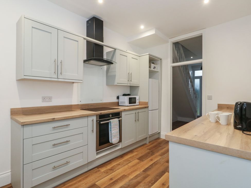 A kitchen with cabinets and appliances at 93 Abbotsbury Road in Weymouth