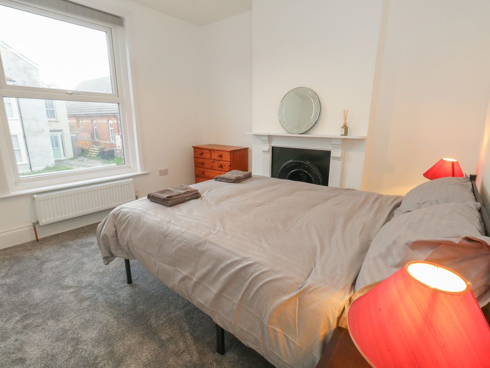 A bedroom with a bed and dresser at 93 Abbotsbury Road in Weymouth