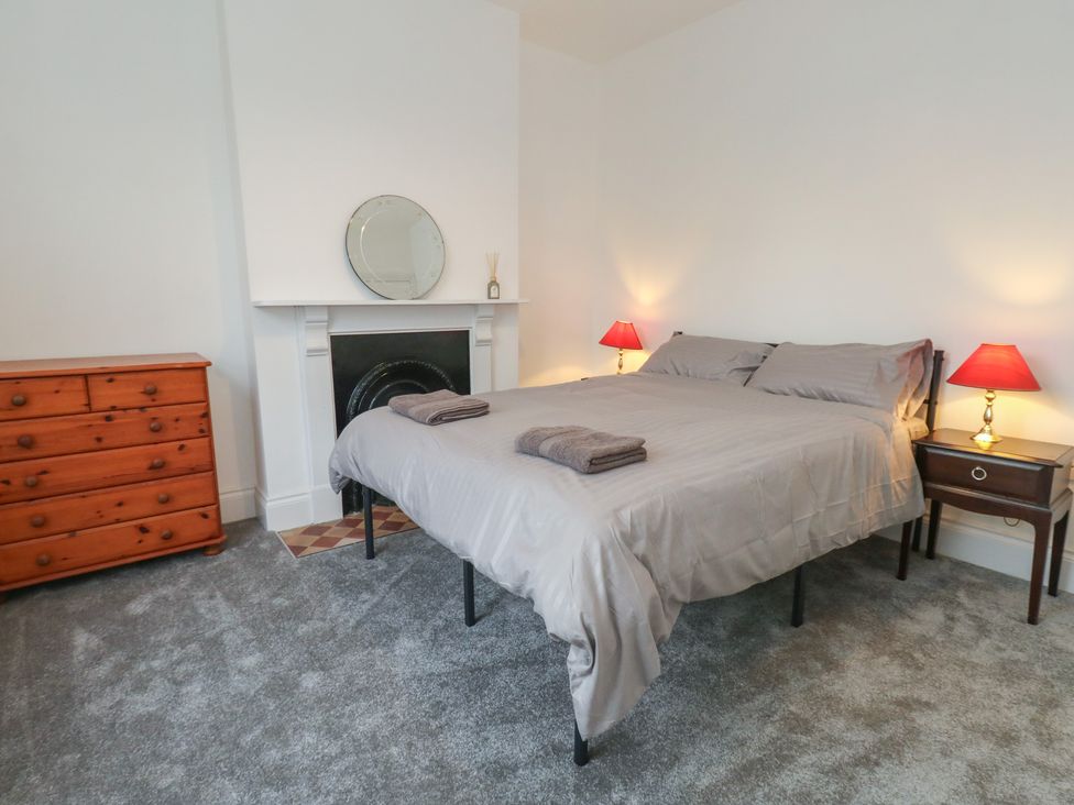 A bedroom with a bed and chest of drawers at 93 Abbotsbury Road, Weymouth