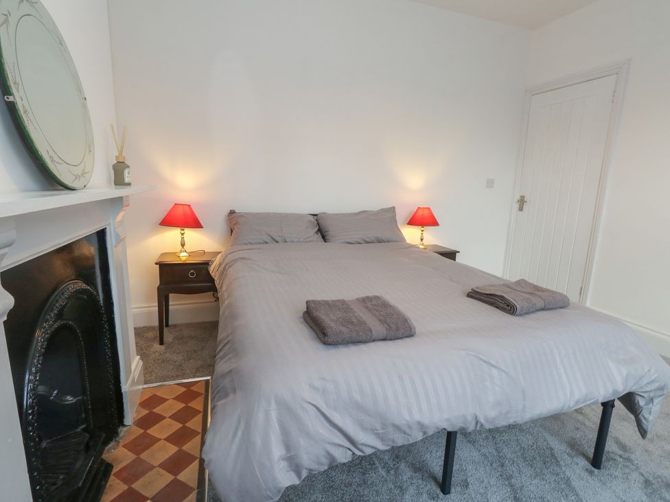 A bedroom with a bed and lamps at 93 Abbotsbury Road in Weymouth