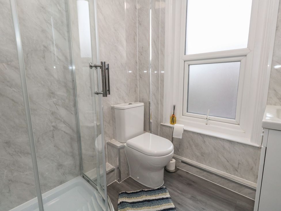 A bathroom featuring a shower, toilet, and sink at 93 Abbotsbury Road in Weymouth