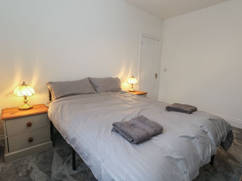 A bedroom with a bed and bedside tables at 93 Abbotsbury Road Weymouth