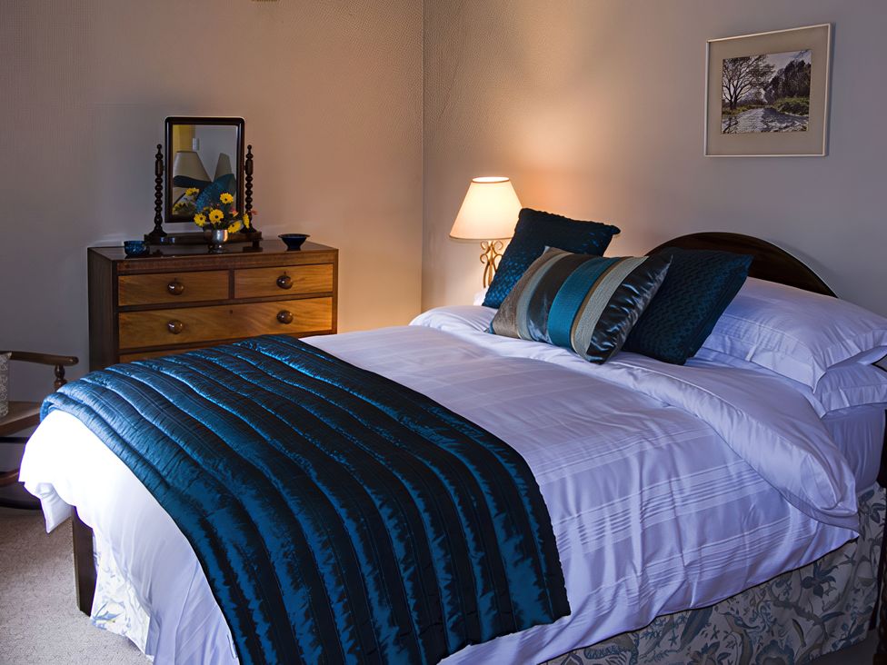 A bedroom with a bed and a lamp at Town Head Farm in Skipton
