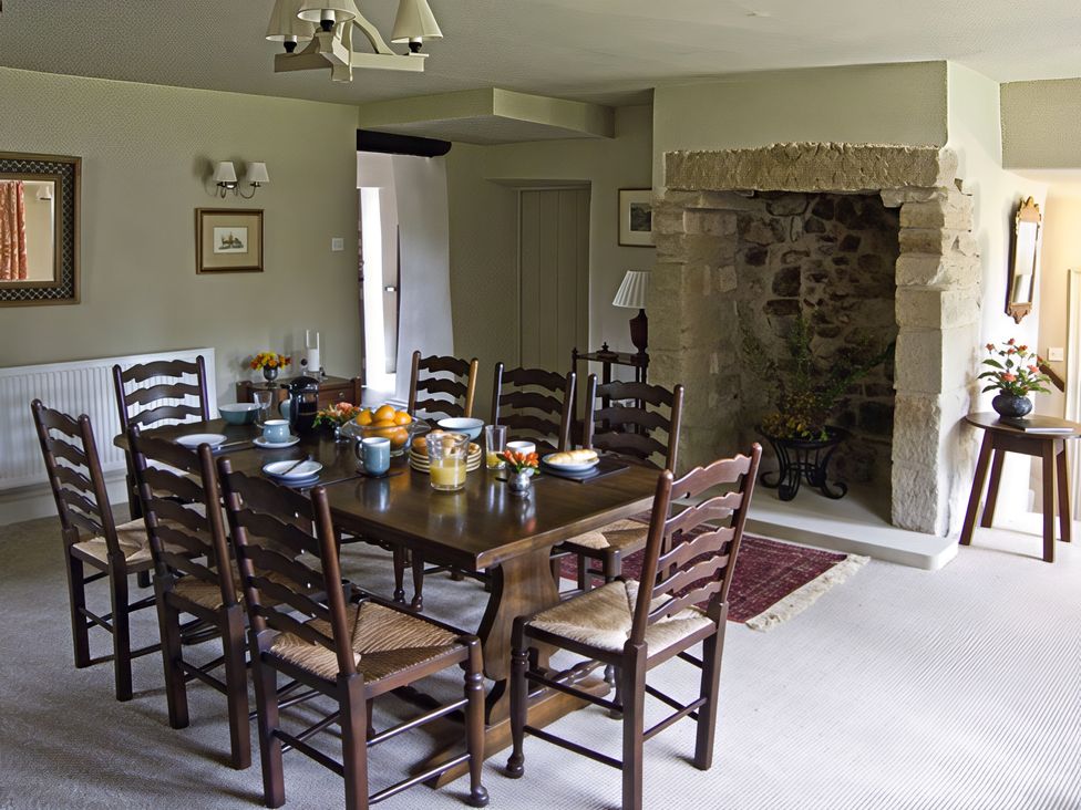 A dining room with a table and chairs at Town Head Farm in Skipton