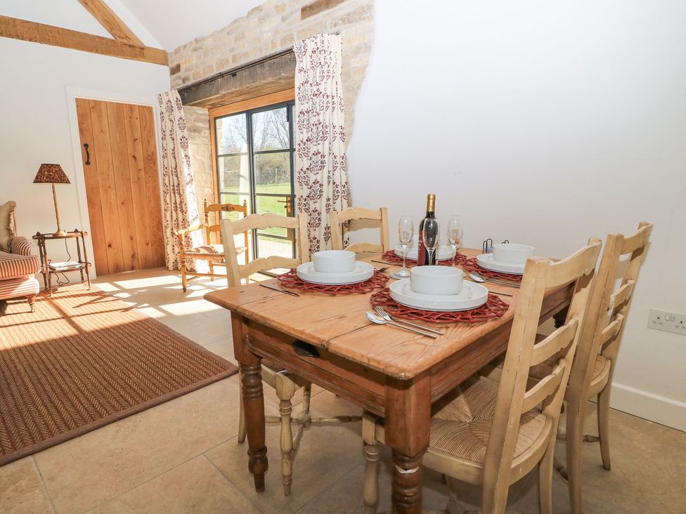 A dining room with a table set for a meal at The Forge in Broadway near Stow-On-The-Wold