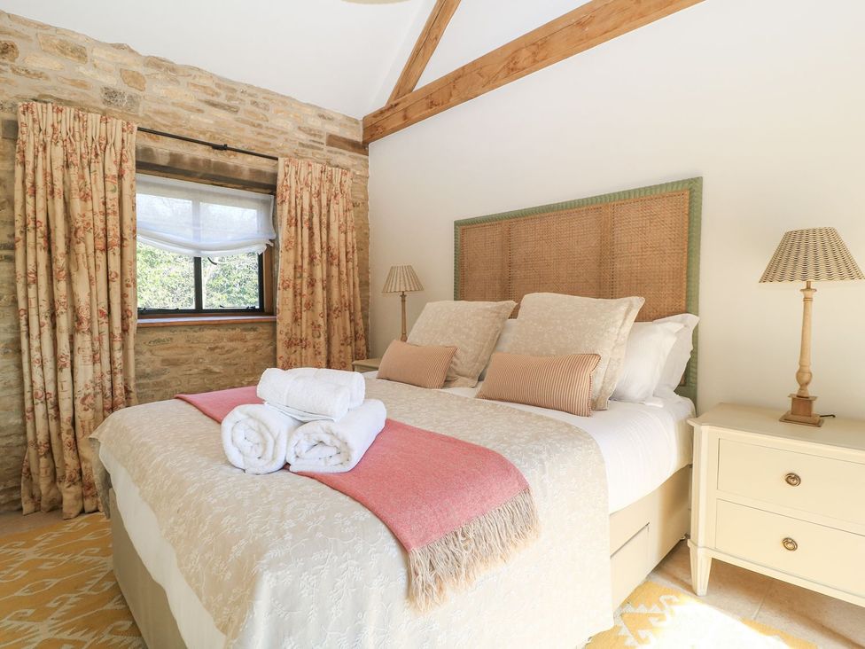 A bedroom with a bed and curtains at The Forge in Broadway near Stow-On-The-Wold