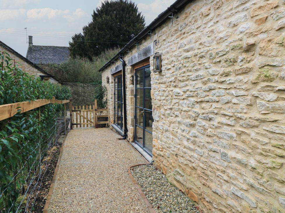 A garden path leading to a door at The Forge in Broadwell near Stow-On-The-Wold
