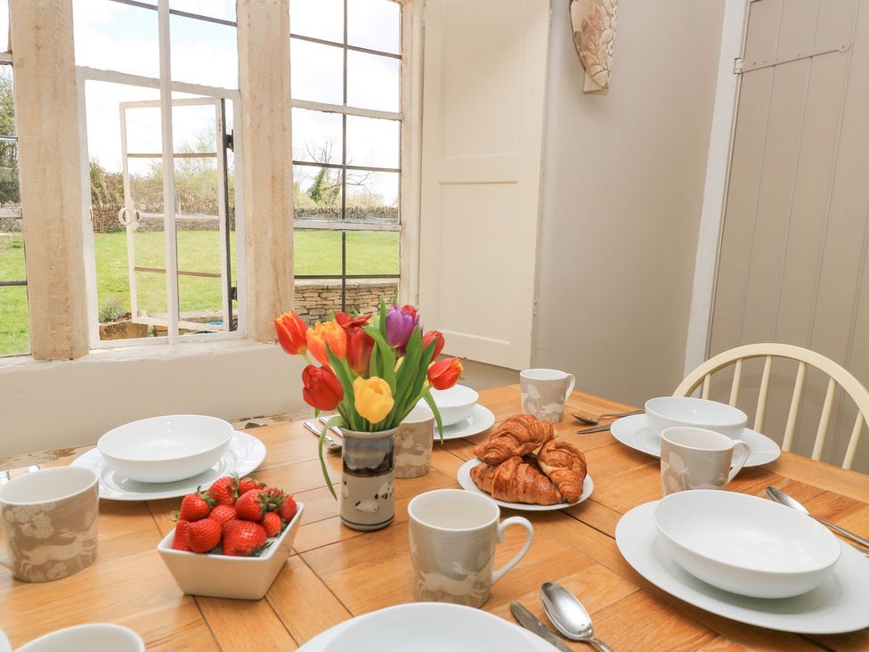 A dining room with a table set for breakfast at The Smithy in Stow on the wold