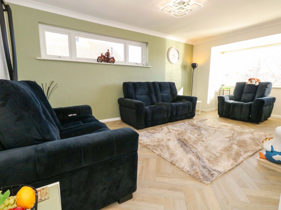 A living room with sofas and a rug at 46 Chafeys Avenue