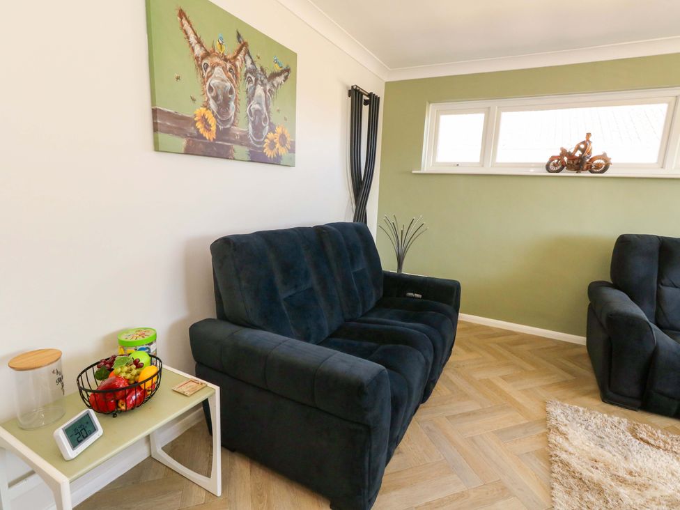 A living room with a sofa and wall art at 46 Chafeys Avenue