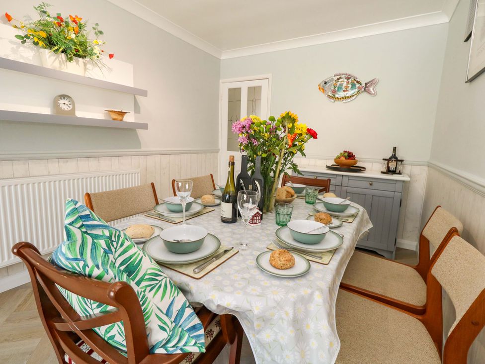 A dining room with a table set for dinner at 46 Chafeys Avenue