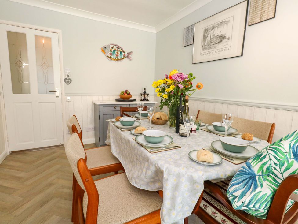 A dining room with a table set for a meal at 46 Chafeys Avenue