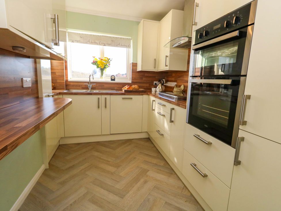 A kitchen with cabinets, countertop, sink and oven at 46 Chafeys Avenue