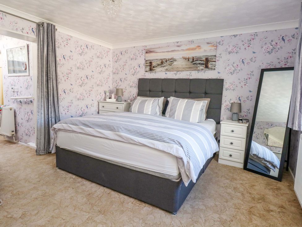 A bedroom with a bed and bedside tables at 46 Chafeys Avenue