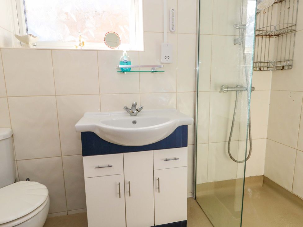 A bathroom with a sink, vanity cabinet, shower and toilet at 46 Chafeys Avenue