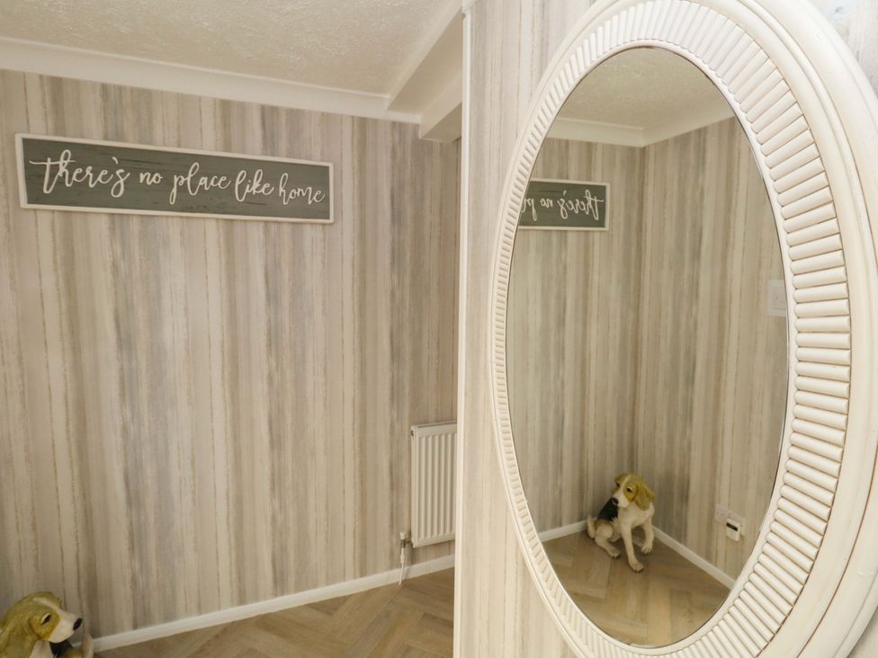 A room with a mirror and a sign at 46 Chafeys Avenue