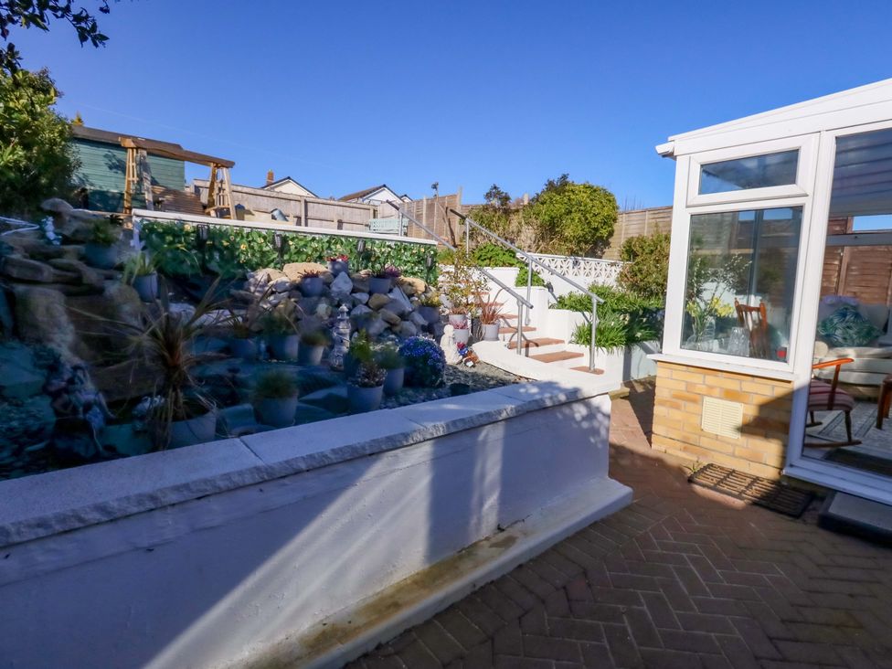 A garden with potted plants and stairs at 46 Chafeys Avenue