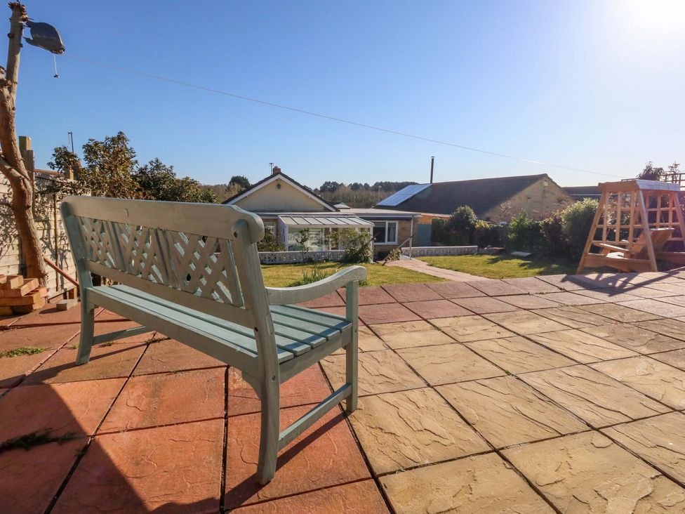 A garden with a bench and view of a house at 46 Chafeys Avenue 